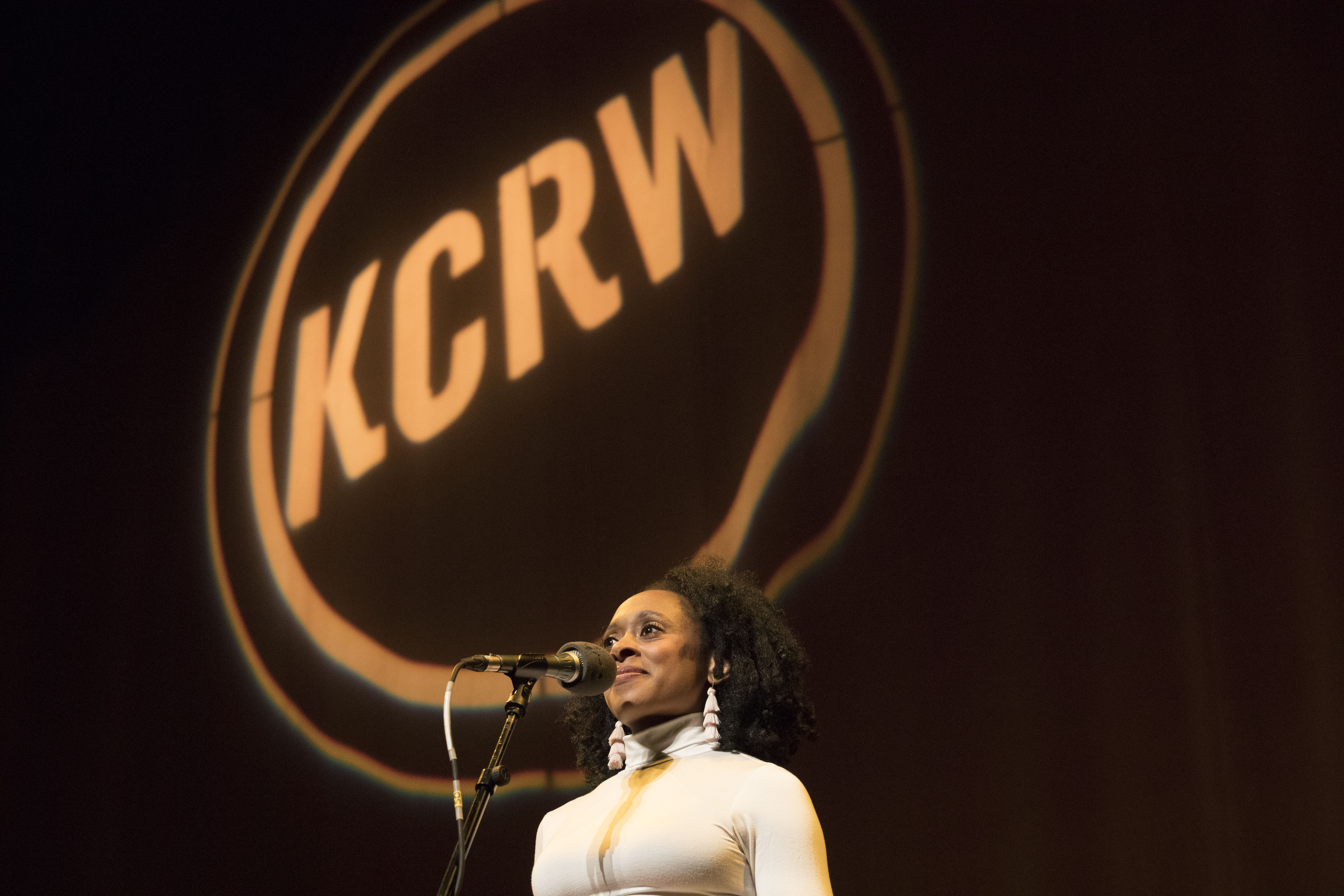 Performer on stage under KCRW logo